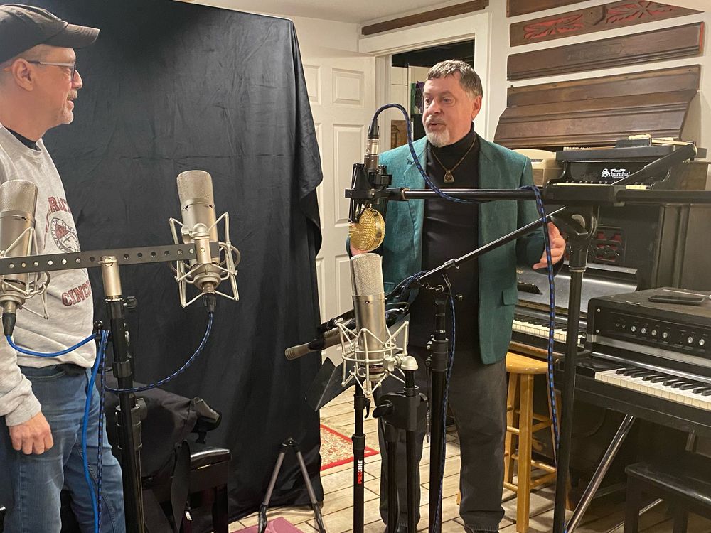 Greg Chako with a musician in his home studio